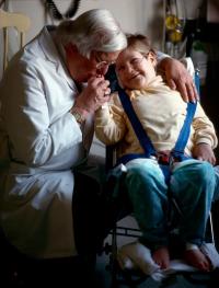 Dr. Arnold P. Gold with a young patient